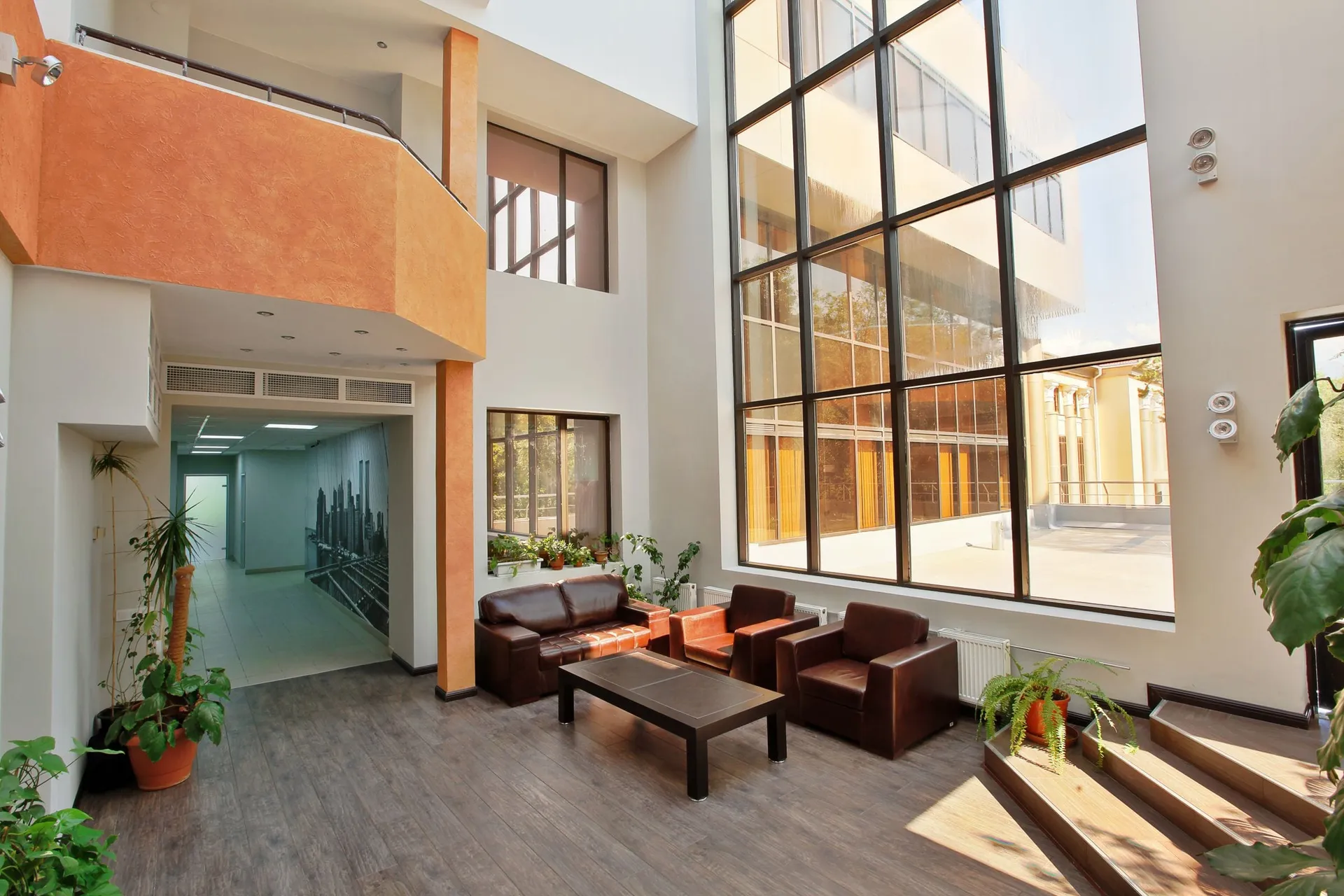Commercial photography of a sunlit building atrium with double-height glass windows in Central Florida