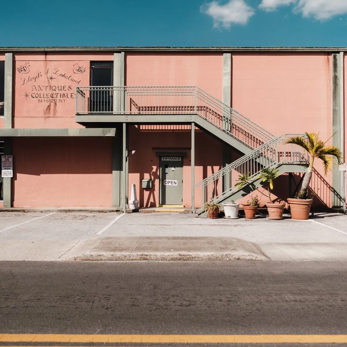 Commercial photography of a historic downtown main street with shops and palm trees in Mount Dora FL
