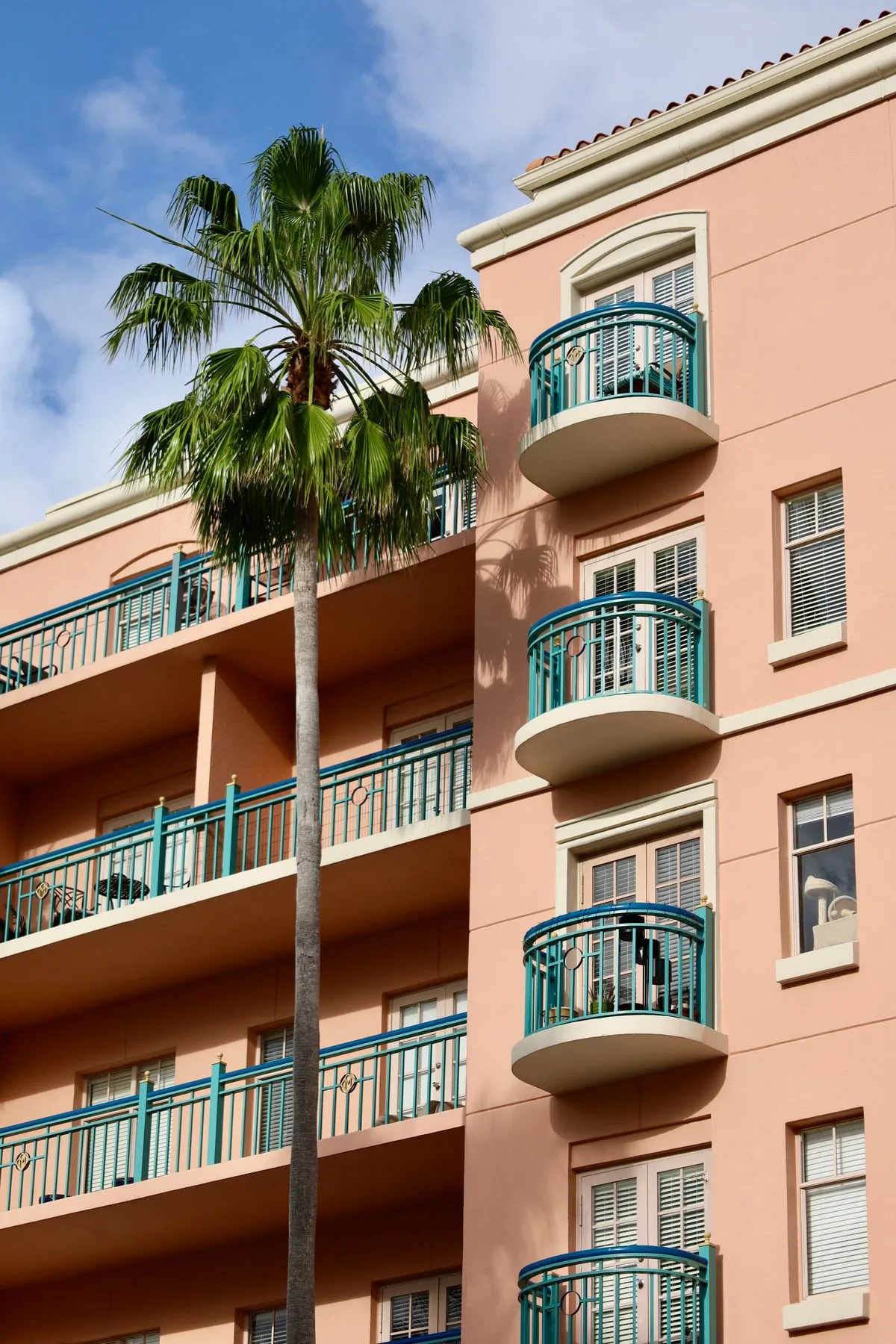 Commercial real estate photography of a Mediterranean-style Central Florida building with balconies and a palm tree
