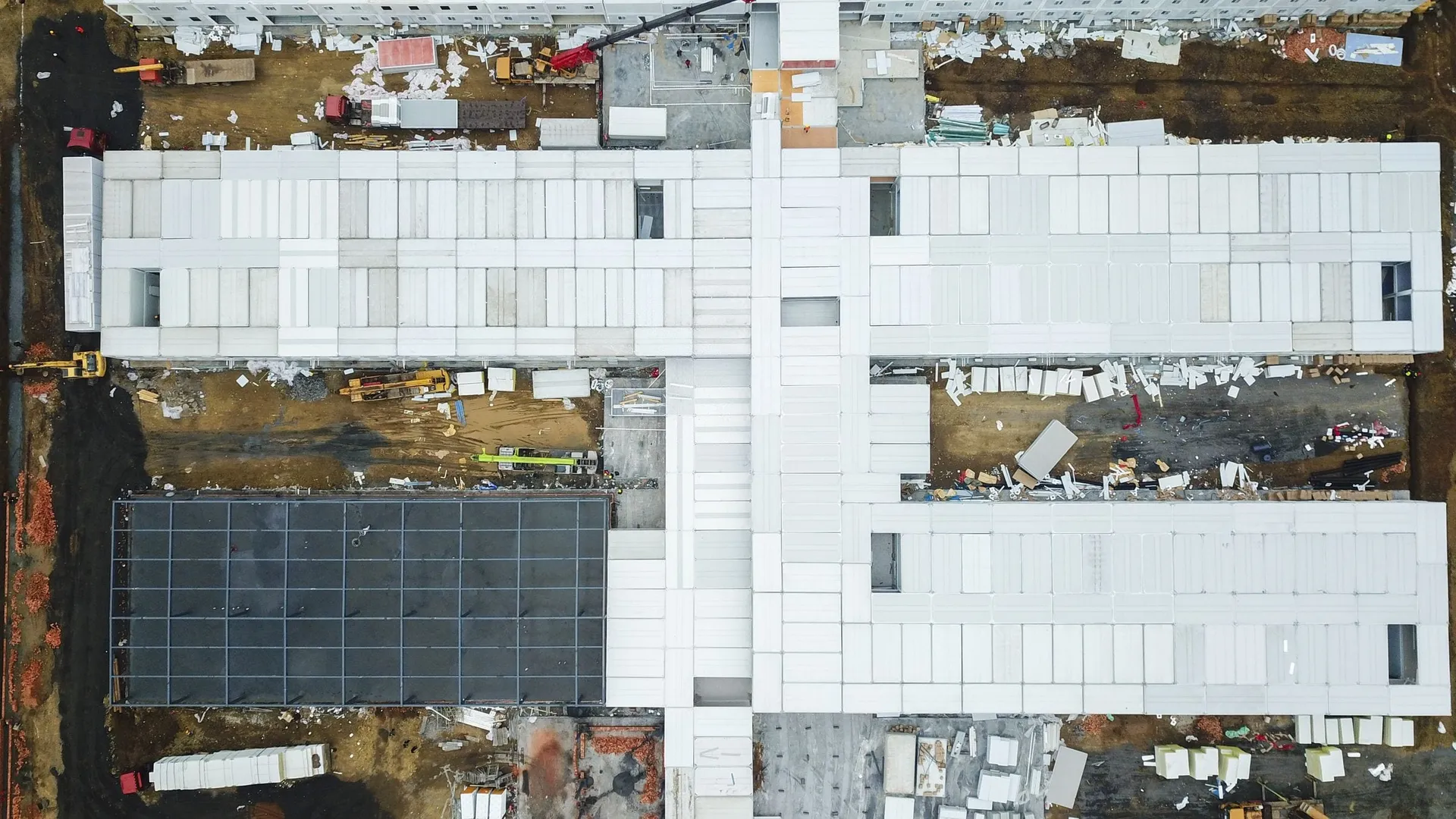 Construction progress drone photography of a Central Florida residential development with crews and materials
