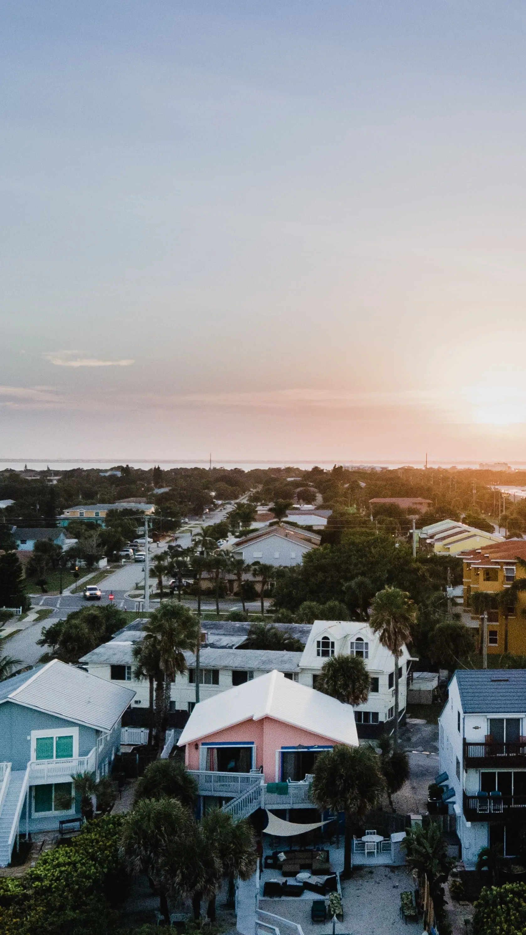 Aerial real estate photography of a lakefront community with winding streets and water views in Leesburg FL
