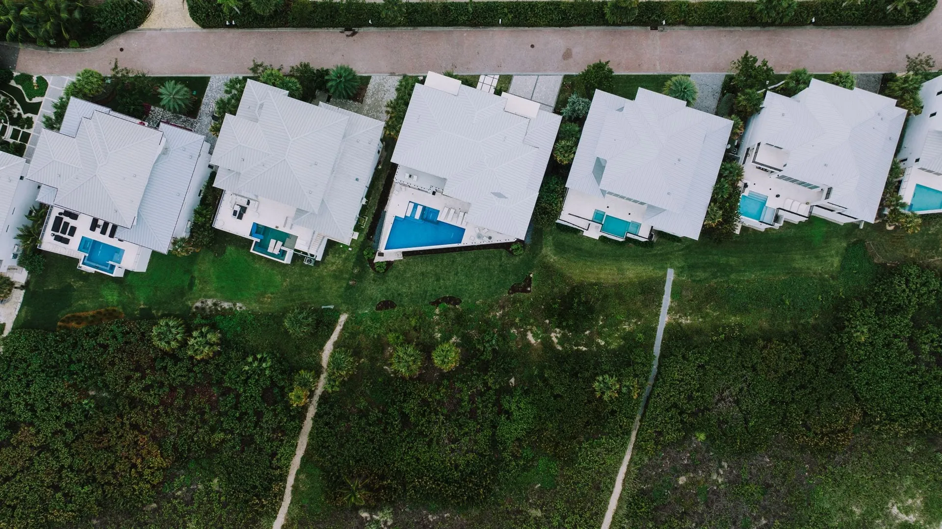 Drone photography of a growing neighborhood with new single-family homes and pools in Wildwood FL
